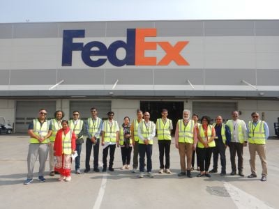 A group of people in front of the FedEx facility